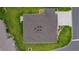 Aerial view of house roof, green grass lawn and landscaped garden at 6991 Sugar Creek Path, The Villages, FL 34762