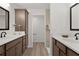 Bathroom featuring double sinks, wood cabinets, and a separate toilet room at 6991 Sugar Creek Path, The Villages, FL 34762