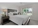 Comfortable bedroom featuring a well-lit nightstand and view through the window at 6991 Sugar Creek Path, The Villages, FL 34762
