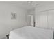 This bedroom features all white decor with a full sized bed at 6991 Sugar Creek Path, The Villages, FL 34762
