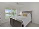 Bright bedroom with a large window and a comfortable full sized bed at 6991 Sugar Creek Path, The Villages, FL 34762