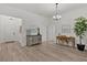 Bright home foyer showcasing a modern chandelier, artwork, and a stylish accent table at 6991 Sugar Creek Path, The Villages, FL 34762
