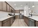 Well-equipped kitchen featuring stainless steel appliances, spacious countertops, and ample storage space at 6991 Sugar Creek Path, The Villages, FL 34762