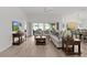 Comfortable living room featuring ample seating, modern decor, and a seamless flow to the dining area at 6991 Sugar Creek Path, The Villages, FL 34762