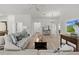 Spacious living room features stylish decor, neutral tones, and lots of natural light at 6991 Sugar Creek Path, The Villages, FL 34762