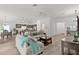 Cozy living room with wood floors, neutral decor, and an open layout to the kitchen and dining area at 6991 Sugar Creek Path, The Villages, FL 34762