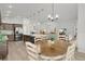 Open-concept living space with a view of the kitchen and dining area, perfect for entertaining guests at 6991 Sugar Creek Path, The Villages, FL 34762