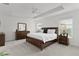 Comfortable main bedroom with neutral decor, a ceiling fan, and carpeted floors at 6991 Sugar Creek Path, The Villages, FL 34762