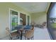 Comfortable screened-in patio area with a full-sized table and additional seating at 6991 Sugar Creek Path, The Villages, FL 34762