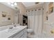 Cozy bathroom with a vanity, a tiled floor, a shower, and decor shelves at 815 Forestwood Dr, Minneola, FL 34715