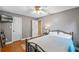 Bedroom featuring a hardwood floor, a ceiling fan, two white doors, and gray walls at 815 Forestwood Dr, Minneola, FL 34715