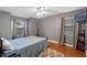 Bedroom with a hardwood floor, ceiling fan, and natural light from windows with curtains at 815 Forestwood Dr, Minneola, FL 34715
