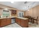 Bright kitchen featuring stainless steel appliances, stone backsplash, and an adjacent dining area at 815 Forestwood Dr, Minneola, FL 34715