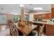 Open concept kitchen with stainless appliances, wooden cabinets, adjacent to the living area at 815 Forestwood Dr, Minneola, FL 34715