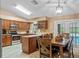 Modern kitchen with stainless steel appliances, granite countertops, and a breakfast nook overlooking the pool at 815 Forestwood Dr, Minneola, FL 34715
