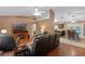 Inviting living room featuring a fireplace, hardwood floors, and comfortable leather seating at 815 Forestwood Dr, Minneola, FL 34715