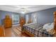 Serene main bedroom with wood floors, neutral walls, and a view of the backyard at 815 Forestwood Dr, Minneola, FL 34715