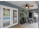 Covered patio with double doors overlooking the pool, ceiling fan, and seating at 815 Forestwood Dr, Minneola, FL 34715