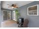 Enclosed patio area with furniture, ceiling fan, and view of the backyard and pool at 815 Forestwood Dr, Minneola, FL 34715