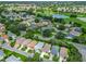 An aerial of a golf course community, featuring lush fairways and pristine water features at 8195 Se 174Th Rowland St, The Villages, FL 32162