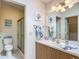 Bright bathroom featuring a single vanity with framed mirror, decorative towels and art, and walk-in shower at 8195 Se 174Th Rowland St, The Villages, FL 32162