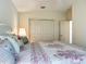 Bedroom featuring a bed with decorative pillows, side tables with lamps, and closet at 8195 Se 174Th Rowland St, The Villages, FL 32162