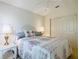 Bedroom featuring a bed with decorative pillows, side tables with lamps, a ceiling fan, and closet at 8195 Se 174Th Rowland St, The Villages, FL 32162
