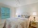 Bedroom features a bed with decorative pillows, side tables with lamps, and a view of the window at 8195 Se 174Th Rowland St, The Villages, FL 32162