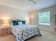 Cozy bedroom featuring a ceiling fan, a patterned comforter, side tables and a window at 8195 Se 174Th Rowland St, The Villages, FL 32162
