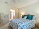 Comfortable bedroom with a sea-themed comforter, ceiling fan, and access to an en-suite bathroom at 8195 Se 174Th Rowland St, The Villages, FL 32162