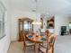 Dining area with wooden table, china cabinet, and view of the kitchen at 8195 Se 174Th Rowland St, The Villages, FL 32162