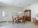 Bright dining room featuring an oval wooden table set and a wooden china cabinet for stylish storage at 8195 Se 174Th Rowland St, The Villages, FL 32162