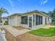 Exterior view of home featuring attached garage and enclosed lanai with patio furniture at 8195 Se 174Th Rowland St, The Villages, FL 32162