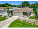 Aerial view of a well-maintained home with a garage, screen porch, and landscaped yard at 8195 Se 174Th Rowland St, The Villages, FL 32162