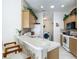 Charming kitchen with white appliances, light wood cabinets and a breakfast bar with seating at 8195 Se 174Th Rowland St, The Villages, FL 32162