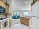 Open kitchen with a view to the living room featuring a blue sofa, offering a connected living space at 8195 Se 174Th Rowland St, The Villages, FL 32162