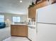 Well-lit kitchen showing white countertops, ample cabinets, and a partial view of the connected living room at 8195 Se 174Th Rowland St, The Villages, FL 32162