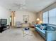 Bright living room featuring plush furniture, neutral carpet, and natural light at 8195 Se 174Th Rowland St, The Villages, FL 32162