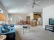 Open-concept living area with plush blue sofa, dining area, and kitchen at 8195 Se 174Th Rowland St, The Villages, FL 32162