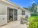 Back patio with seating, exterior lighting, and sliding glass doors at 8195 Se 174Th Rowland St, The Villages, FL 32162