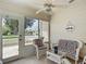 Screened-in porch with wicker furniture and a 