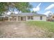 Backyard view with a patio and windows in the back of the house at 832 Willow Run St, Minneola, FL 34715