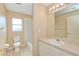 Bathroom with a toilet, sink, mirror, and bathtub at 832 Willow Run St, Minneola, FL 34715