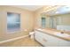 Bathroom with double sinks, large mirror, and a shower and tub combination at 832 Willow Run St, Minneola, FL 34715