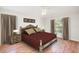 Cozy bedroom with a large bed, side tables, and curtains at 832 Willow Run St, Minneola, FL 34715