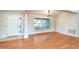 Bright dining area with wood floors, column, large window, and chandelier at 832 Willow Run St, Minneola, FL 34715