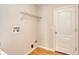 This is the laundry room with a shelf, door, and wood floors at 832 Willow Run St, Minneola, FL 34715