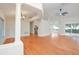 Bright open living space featuring wood floors, high ceilings, and smooth transition to kitchen at 832 Willow Run St, Minneola, FL 34715