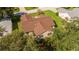Aerial view of home featuring a brown roof, beige siding, and mature landscaping at 8537 Se 177Th Bartram Loop, The Villages, FL 32162