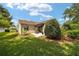 A cozy backyard offers a patio and attractive landscaping for outdoor enjoyment at 8537 Se 177Th Bartram Loop, The Villages, FL 32162